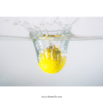lemon dropping into water